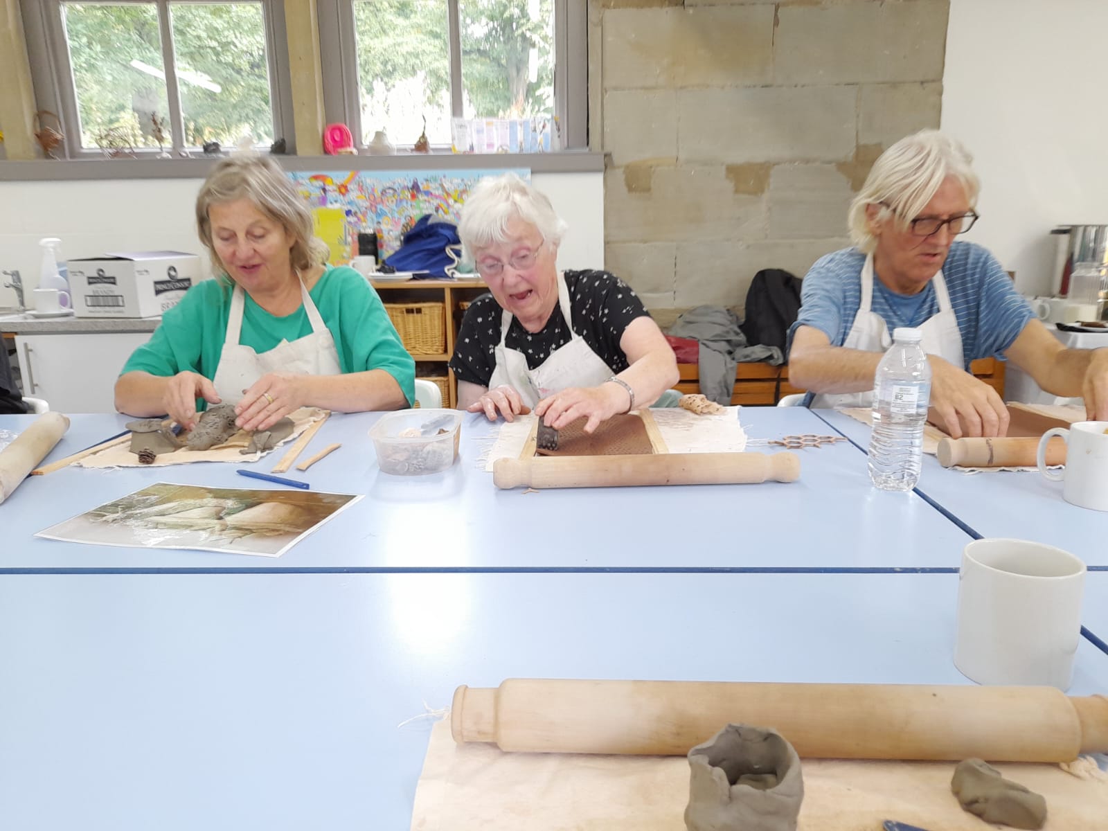 hoot staff and participants sculpting at a table