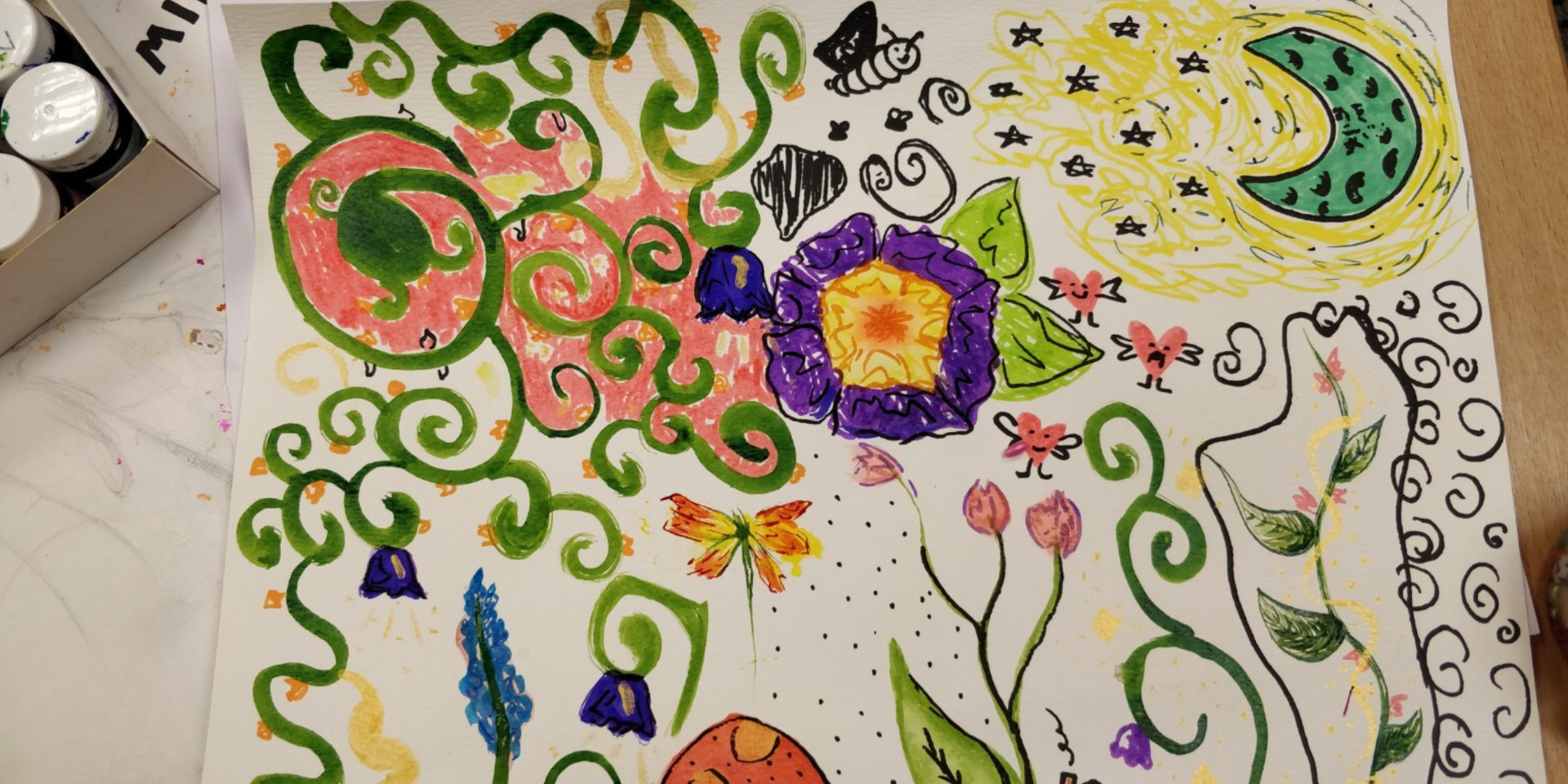 A piece of paper with colour swirls and doodles. 
