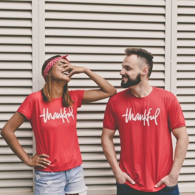 Two people wearing t-shirts saying 'Thankful'