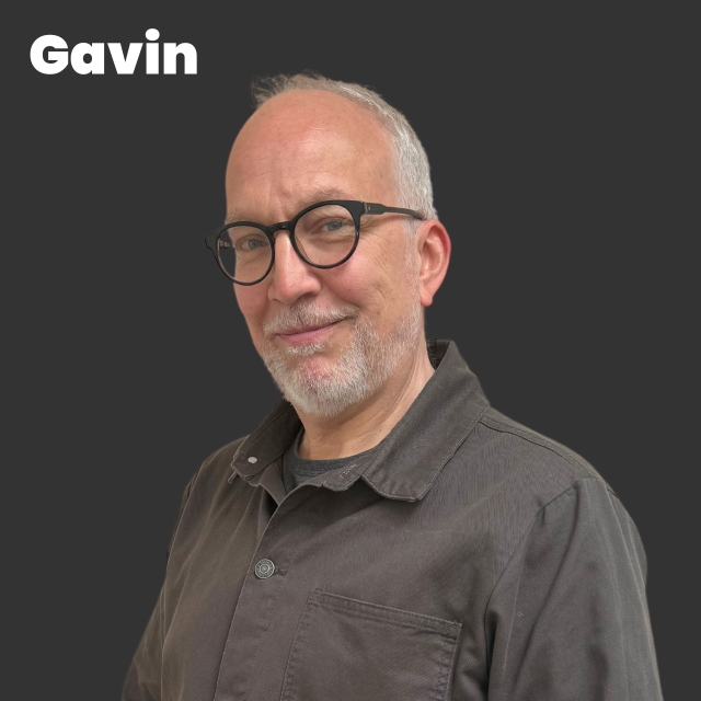 Picture of Gavin, white man, short white hair, slight beard, glasses,  grey shirt